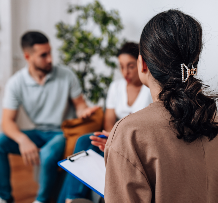 a blurred image of a couple talking during a couples counselling session.